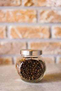 Glass jar with roasted coffee in the kitchen or bar