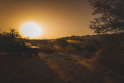 Scenic view of field against sky during sunset