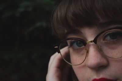 Close-up portrait of woman in eyeglasses outdoors