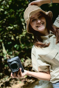 Young women photographer in enjoy emotion and hand holding camera