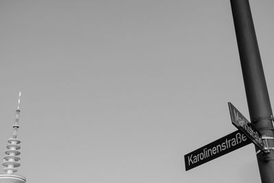 Low angle view of information sign against sky