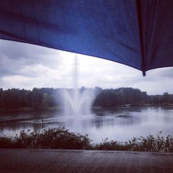 Water splashing on fountain against sky