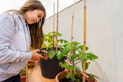 Woman holding potted plant