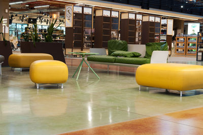 Empty chairs and tables in building