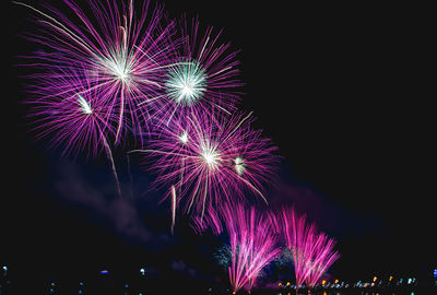 Low angle view of firework display at night