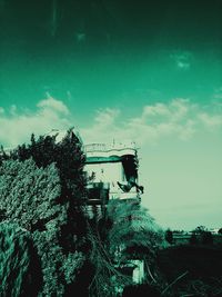 Low angle view of trees and buildings against sky