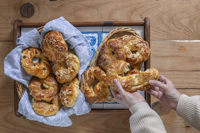 High angle view of hand holding bread on table