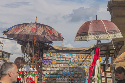 People by traditional building against sky