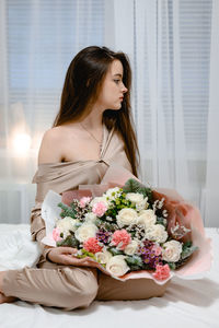 Young woman holding bouquet
