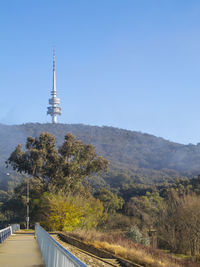 View of tower on mountain against blue sky