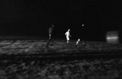 Children on field at night