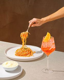 Cropped hand of woman preparing food on table