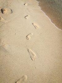 High angle view of footprint on sand at beach