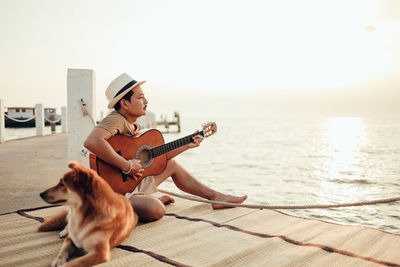 Man with dog sitting outdoors