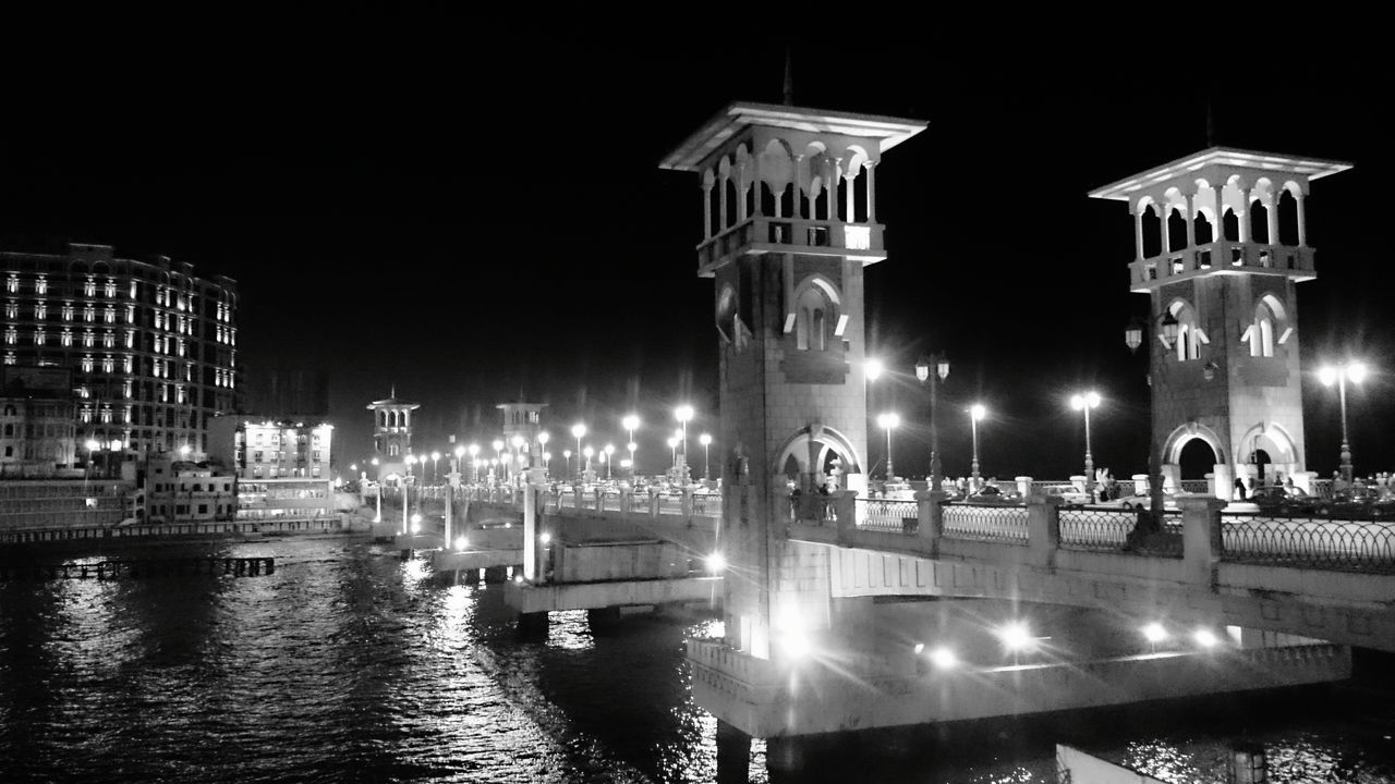 illuminated, built structure, water, architecture, night, building exterior, clear sky, reflection, waterfront, travel destinations, famous place, river, tourism, travel, city, copy space, connection, bridge - man made structure, outdoors, capital cities