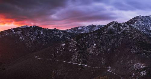 Scenic view of snowcapped mountains against sky during sunset