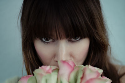 Close-up portrait of beautiful young woman over white background