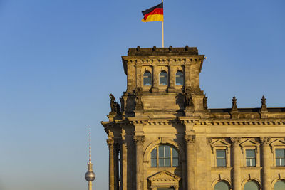 Low angle view of historical building against clear blue sky