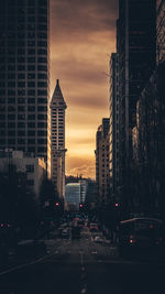 View of city street and buildings at sunset