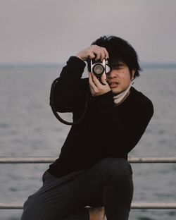 Young woman photographing through camera