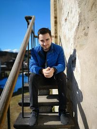 Portrait of young man sitting outdoors