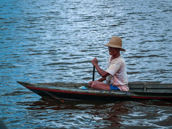 Woman sitting on boat in lake