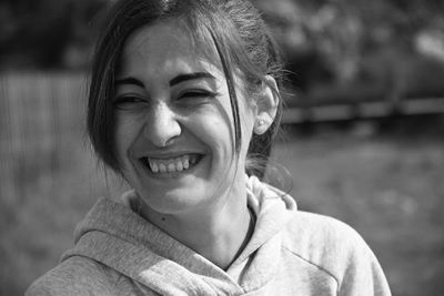 Close-up of smiling young woman looking away