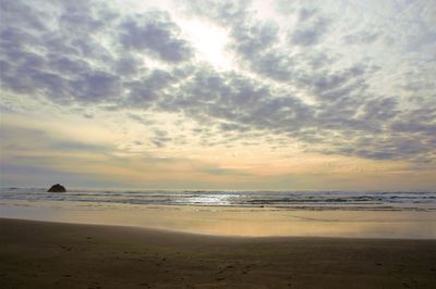 Scenic view of beach against sky during sunset