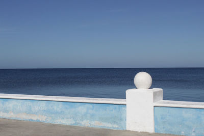 Scenic view of sea against clear blue sky