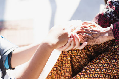 Midsection of woman holding hands