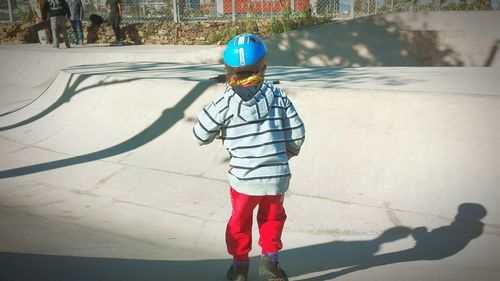 Rear view of boy with umbrella