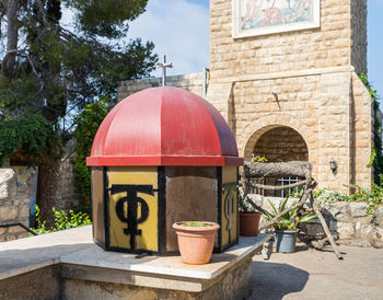 Graffiti on wall by building against trees