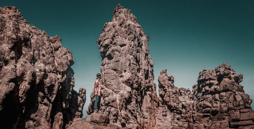 Low angle view of rock formation against sky