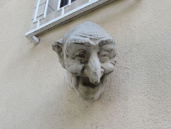 Low angle view of statue against wall