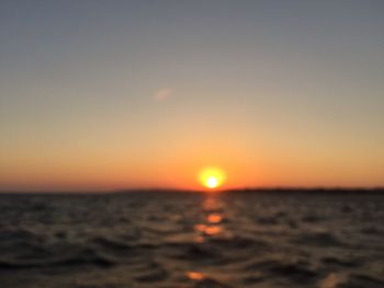 Scenic view of sea against clear sky during sunset