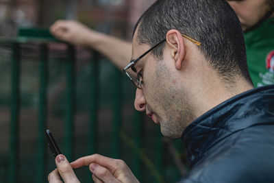 Portrait of young man using mobile phone