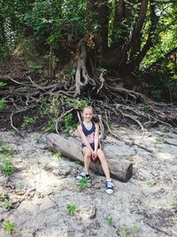 Full length portrait of young woman in forest