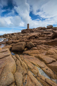 Low angle view of rock formation on beach against sky