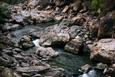 High angle view of stream flowing through rocks