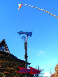 Low angle view of flags against sky