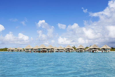 Scenic view of sea and houses against sky