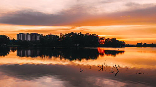 Scenic view of lake against orange sky