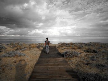 Full length of man standing on land against sky