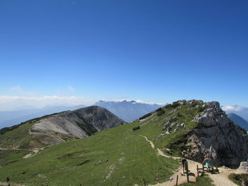 Scenic view of mountains against blue sky