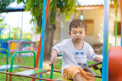 Full length of boy playing in playground