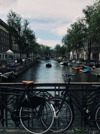 Bicycles parked in water against sky