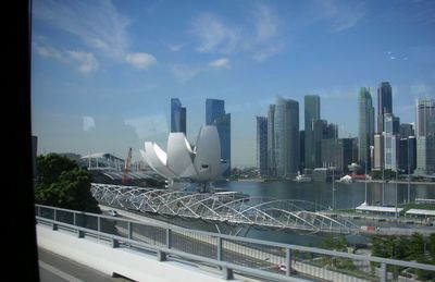Modern buildings in city against cloudy sky