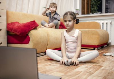 Online hobby, fitness, distant training. young ballerina practicing choreography during online class