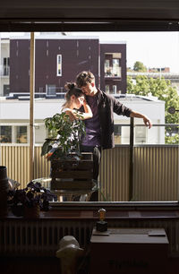 Couple standing on balcony