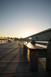 View of empty bridge against clear sky at sunset